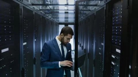 IT Engineer in Data Center Opens Server Rack Cabinet Door and Connects to It  Stock Photos