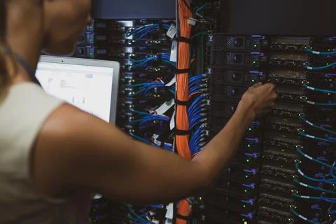 IT engineer   doing routine maintenance server rack Stock Photos