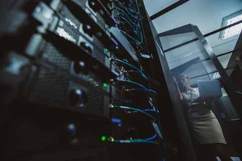 IT engineer   doing routine maintenance server rack Stock Photos