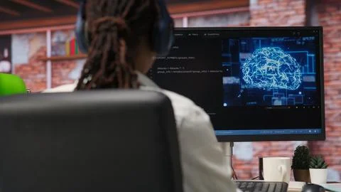 IT engineer drinking coffee, using computer at home for AI computing 库存照片