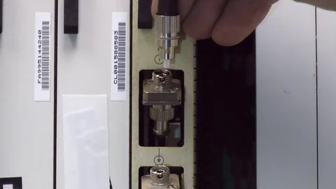 IT engineer insert optical patch cord in card on datacenter, screw up, close-up Stock Footage 81365975