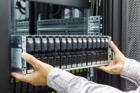 IT Engineer installs JBOD  to rack in datacenter Stock Photos