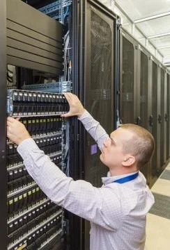 IT Engineer installs JBOD  to rack in datacenter Stock Photos
