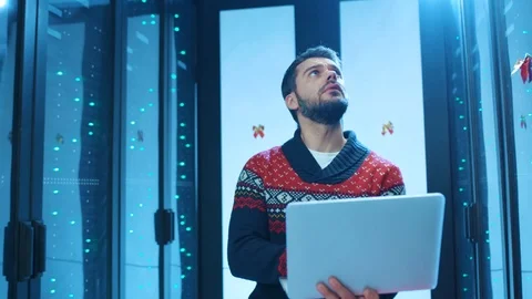 IT engineer with laptop walking inside dark non-stable server room. Joyful Stock Footage 121121759