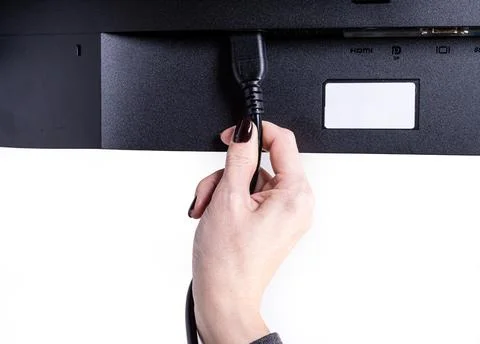 IT engineer Man hand inserts cable into monitor. Man hand connecting the DVI Stock Photos