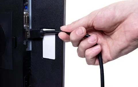 IT engineer Man hand inserts cable into monitor. Man hand connecting the DVI Stock Photos