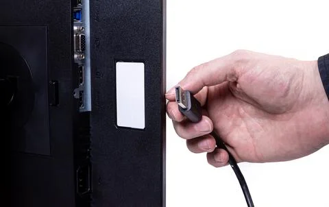 IT engineer Man hand inserts cable into monitor. Man hand connecting the DVI Stock Photos