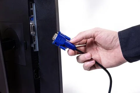 IT engineer Man hand inserts cable into monitor. Man hand connecting the DVI Stock Photos
