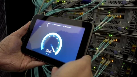 IT engineer measures network speed with a tablet computer in hand. LEDs blink. Video stock 102651025
