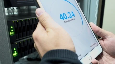 IT engineer measures network speed. With a tablet computer in hand. The Stock Footage 117840127