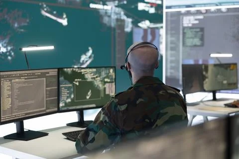IT engineer operator examines surveillance footage from satellite system 库存照片