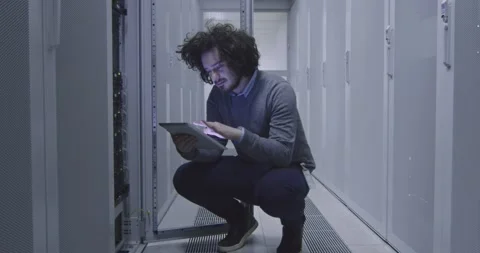IT engineer or data science specialist working on tablet computer in server room Vídeos de archivo 219481587