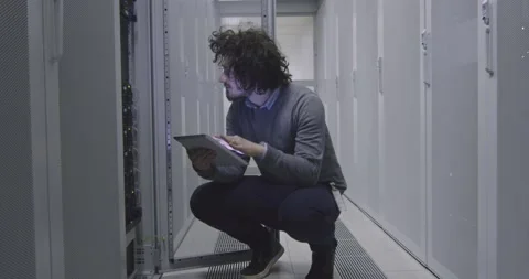 IT engineer or data science specialist working on tablet computer in server room Vídeos de archivo 219481687