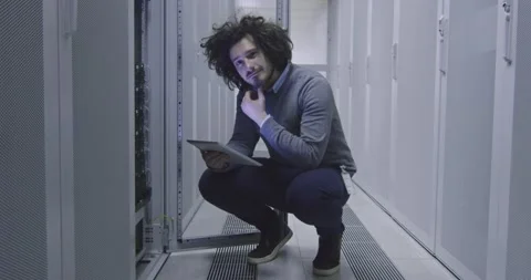 IT engineer or data science specialist working on tablet computer in server room Vídeos de archivo 219481738