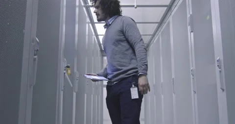 IT engineer or data science specialist working on tablet computer in server room Vídeos de archivo 219482285
