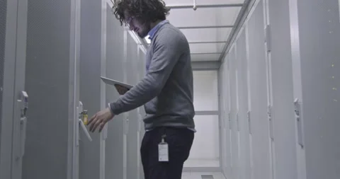 IT engineer or data science specialist working on tablet computer in server room Vídeos de archivo 219482484