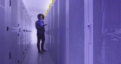 IT engineer or data science specialist working on tablet computer in server room Vídeos de archivo 219485622