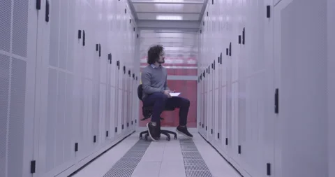 IT engineer or data science specialist working on tablet computer in server room Vídeos de archivo 219541893