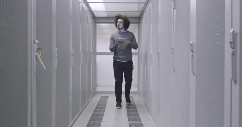 IT engineer or data science specialist working on tablet computer in server room Vídeos de archivo 219541943