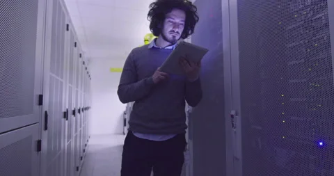 IT engineer or data science specialist working on tablet computer in server room Vídeos de archivo 219542232