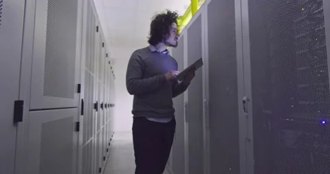 IT engineer or data science specialist working on tablet computer in server room Vídeos de archivo 219542326