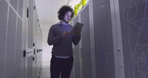 IT engineer or data science specialist working on tablet computer in server room Vídeos de archivo 219542395