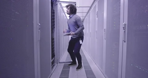 IT engineer or data science specialist working on tablet computer in server room Vídeos de archivo 219542478