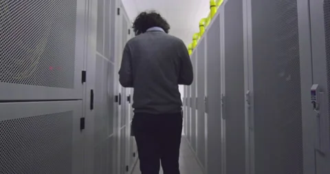 IT engineer or data science specialist working on tablet computer in server room Vídeos de archivo 219542598