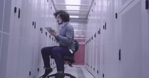 IT engineer or data science specialist working on tablet computer in server room Vídeos de archivo 219542687
