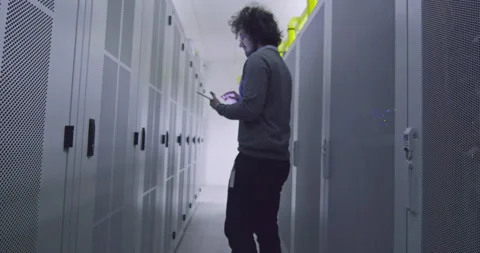 IT engineer or data science specialist working on tablet computer in server room Vídeos de archivo 219542811