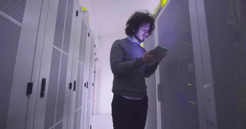 IT engineer or data science specialist working on tablet computer in server room Vídeos de archivo 219542951