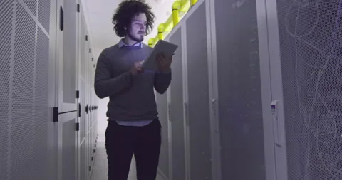 IT engineer or data science specialist working on tablet computer in server room Vídeos de archivo 219543008
