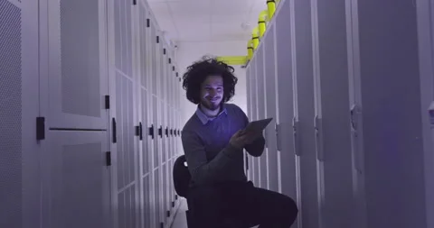 IT engineer or data science specialist working on tablet computer in server room Vídeos de archivo 219543171