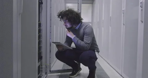 IT engineer or data science specialist working on tablet computer in server room Vídeos de archivo 219543207