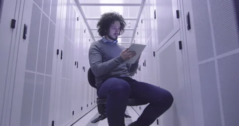 IT engineer or data science specialist working on tablet computer in server room Vídeos de archivo 219543249