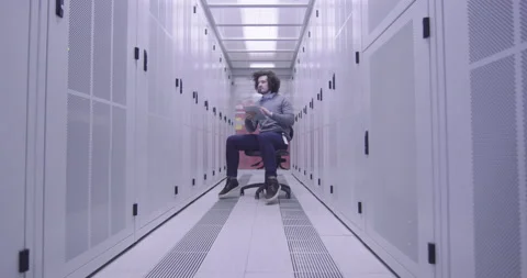 IT engineer or data science specialist working on tablet computer in server room Vídeos de archivo 219543374