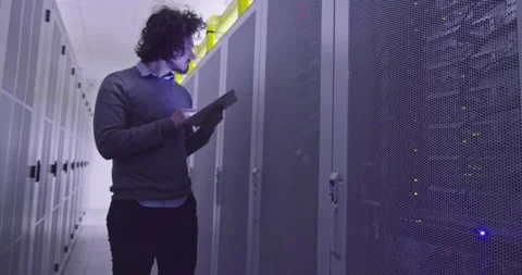 IT engineer or data science specialist working on tablet computer in server room Vídeos de archivo 219543598