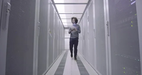 IT engineer or data science specialist working on tablet computer in server room Vídeos de archivo 219543733