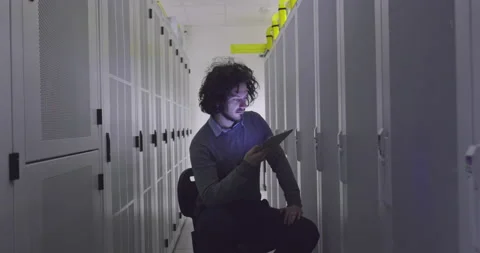 IT engineer or data science specialist working on tablet computer in server room Vídeos de archivo 219543806