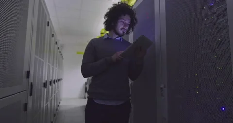 IT engineer or data science specialist working on tablet computer in server room Vídeos de archivo 219544015