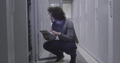 IT engineer or data science specialist working on tablet computer in server room Vídeos de archivo 219544091