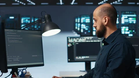 IT engineer overseeing server room, running code, troubleshooting servers Stock Footage 275493657