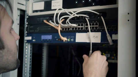 IT Engineer Patching Network Equipment In Server Room. 動画素材 104178335