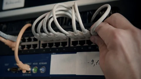 IT Engineer Patching Network Equipment In Server Room. 動画素材 104178358