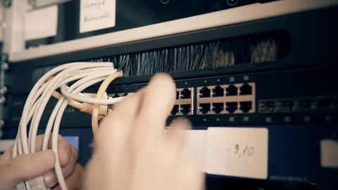 IT Engineer Patching Network Equipment In Server Room. 動画素材 104178522