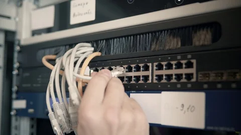 IT Engineer Patching Network Equipment In Server Room. 動画素材 104178541