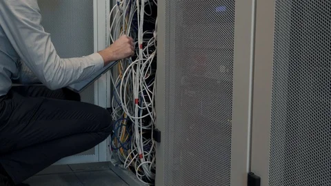 IT Engineer Patching Network Equipment In Server Room. 動画素材 104179366