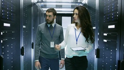 IT Engineer Shows Working Data Center/ Server Room to Female Chief Engineer Stock Footage 73668344