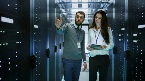IT Engineer Shows Working Data Center / Server Room to Female Chief Engineer  스톡 사진