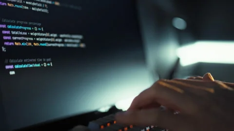 An IT engineer swiftly codes intricate algorithms on the keyboard refining t Stock Footage 331315616